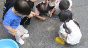 水たまりの様子を見る1歳児