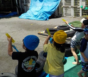 水遊びをする子どもたち(空中に水鉄砲をうっている。)