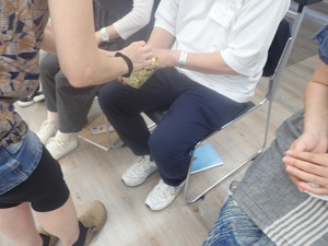 五感をつかったエクササイズ　容器の中に入ったものを目隠しの状態でさわっている
